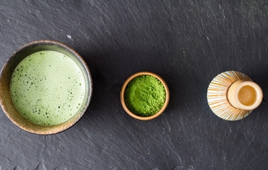 green matcha tea prepearing on stone black table 