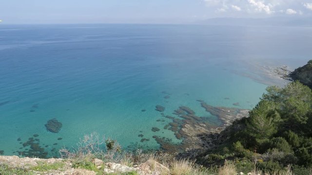 Beautiful view looking down from a mountain at the clear turquoise waters on the coast of Ayla Napa, Cyprus