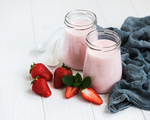 Jars with strawberry yogurt