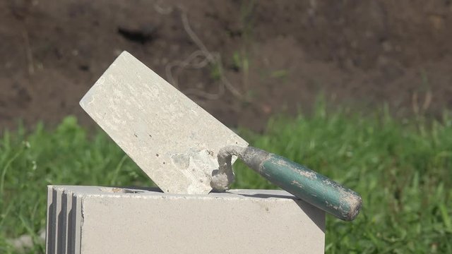 mason's trowel on masonry