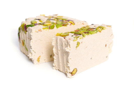 Tahini-based halva with pistachios. Isolated on white background