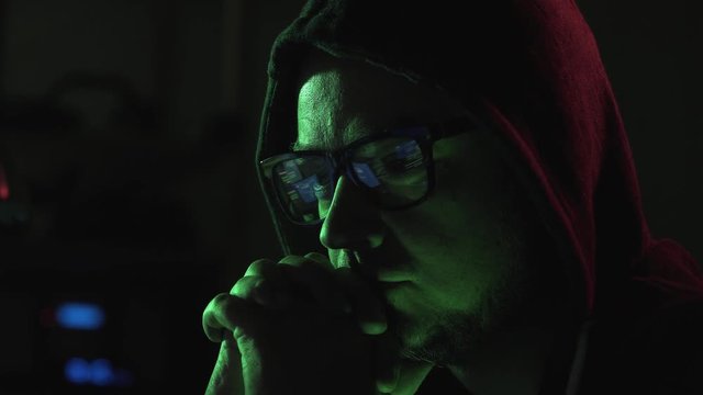 Hacker and running code on the computer screen