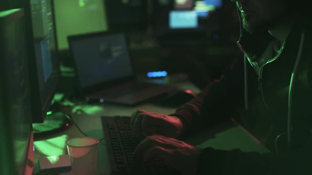 Black hat hacker working in his basement late at night