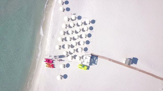 umbrellas on the white beach aerial view - shot in Italy (Sardinia)