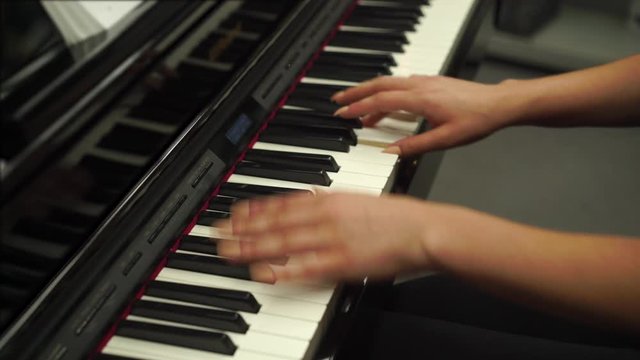 Womans Hands Playing Piano