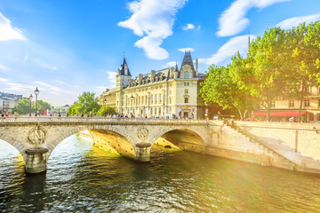 Sunset on Pont au Change bridge over river Seine and Conciergerie: a historic Parisian building within Palais de Justice complex, Ile de la Cite.Castle in former Royal Palace and Paris prison, France.