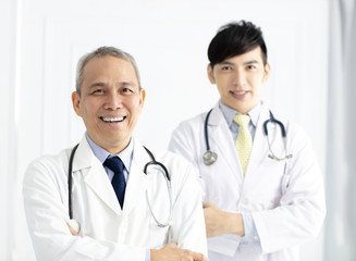 Fototapeta premium Portrait of two smiling asian doctors