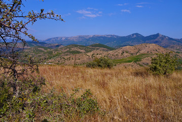 a panorama of rocky mountains and dry hills near the sea bay in the south