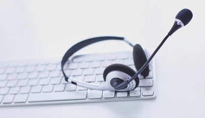 Communication support, call center and customer service help desk. VOIP headset on laptop computer keyboard
