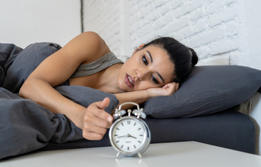 pretty latin woman can't sleep in insomnia concept