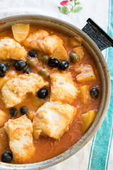 Salted cod stewed with olives