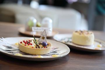 Lemon tart pie topping with chocolate ball sweet dessert on wood background
