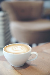 cappuccino or Latte art coffee made from milk on the wood table in coffee shop
