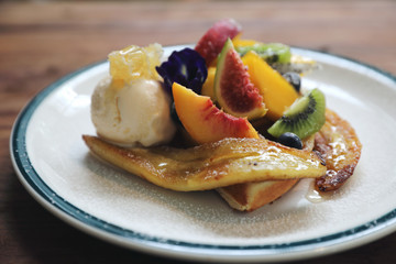 Dessert baked Waffle with fruits kiwo grape berry and vanilla ice cream vintage style