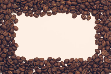 Background of coffee beans. Coffee texture. A place to write a text. Cinnamon sticks and cardamom.