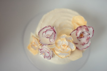 white cake on a white background with a wafer flowers