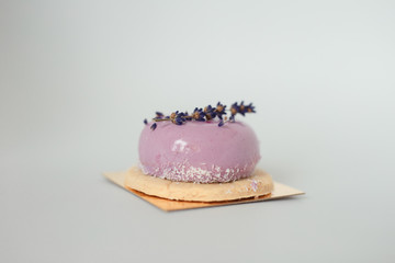 violet cake with branch of lavender on white background