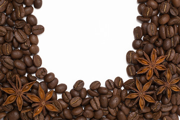 Background of coffee beans. Coffee texture. A place to write a text. Cinnamon sticks and cardamom.