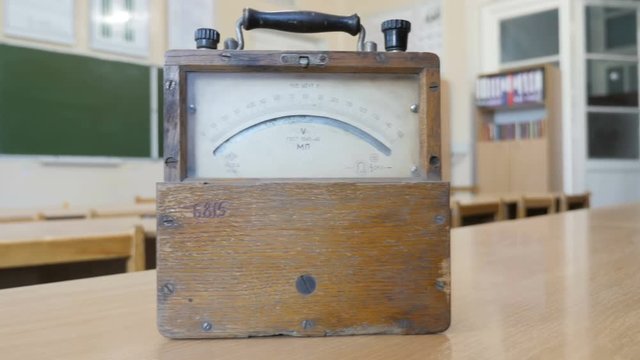 Retro ammeter or voltmeter which is using for measure of electric low current or voltage values. The vintage voltmeter in physical laboratory of School, College, University

