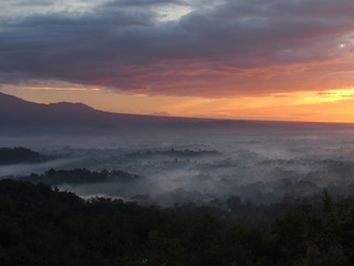 Borobudur Temple in a beautiful foggy sunrise seen from Punthuk Setumbu Hill