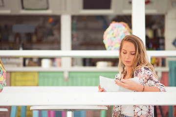 Young woman sitting in a beach bar