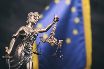 Obraz premium Scales of Justice, Justitia, Lady Justice in front of the European Union flag in the background.