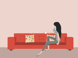 woman sitting on sofa with coffee mug