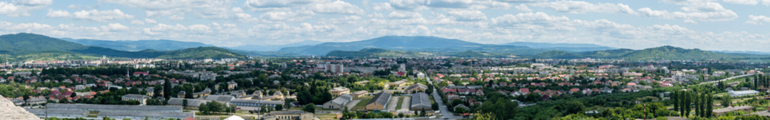 Panoramic view of the big city in the mountains. The lady looks so tiny