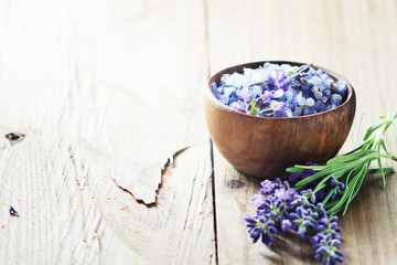 Obraz na płótnie Canvas Lavender salt with flowers on wooden table.