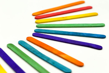 Colorful ice cream sticks on white background