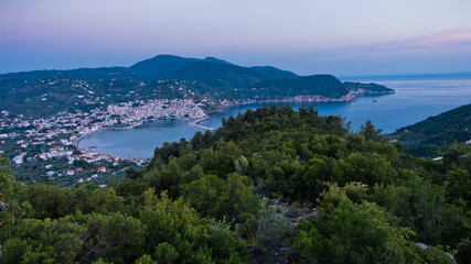 Aerial view of Skopelos harbour and town before sunrise, island of Skopelos, Greece
