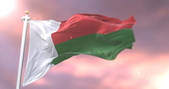 Madagascar flag waving at wind in slow at sunset, loop
