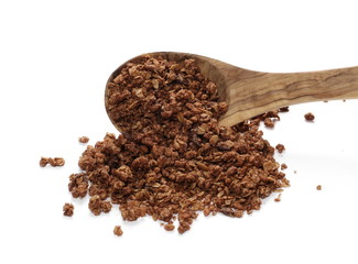 Crunchy chocolate granola, muesli pile in wooden spoon isolated on white background