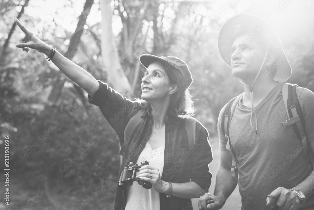 Wall mural couple trekking together in the forest