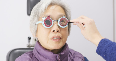 Senior woman having her eyes examine