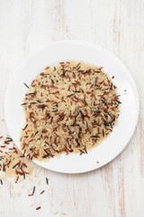 white, brown and black rice in white plate