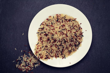 white, brown and black rice in white plate