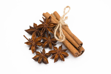 Cinnamon sticks and cardamom on a white background. Aromatic spices.
