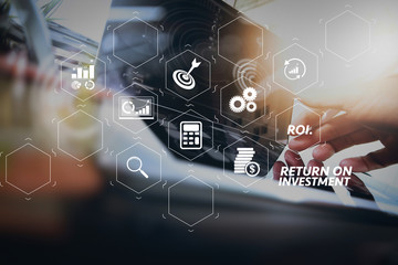 close up of business man hand working on laptop computer with digital business strategy diagram on wooden desk as concept