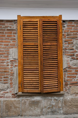 Wooden blinds on windows on the street