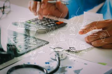 Healthcare costs and fees concept.Hand of smart doctor used a calculator for medical costs in modern hospital © everythingpossible