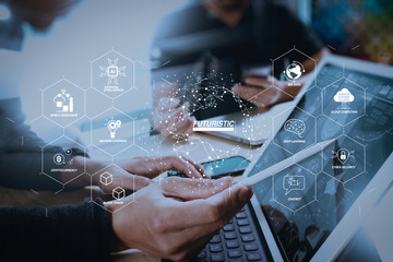 two colleague web designer discussing data and digital tablet docking keyboard and computer laptop with smart phone and design diagram on marble desk,sun light effect