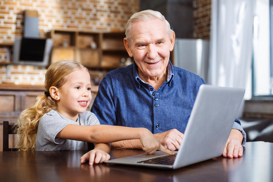 Cute little girl using laptop with his granddaughter