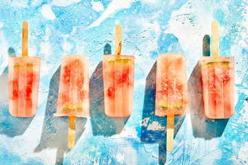 Row of homemade frozen iced melon popsicles