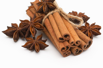 Cinnamon sticks and cardamom on a white background. Aromatic spices.