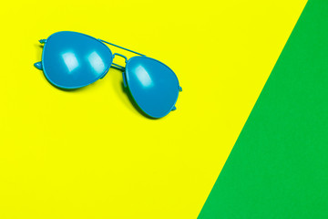 Fashionable sunglasses on minimal colorful background