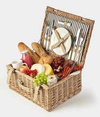 Old vintage style picnic hamper packed with food