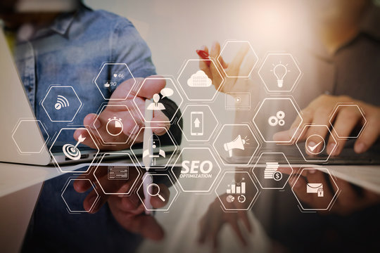 Team work concept,businessman hand attending video conference in modern office.Digital tablet laptop computer design smart phone using. Sun effects, Blurred background