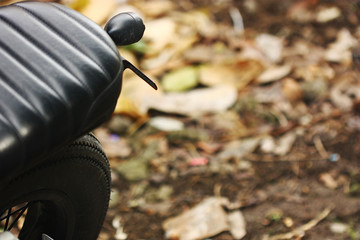 selective focus of rear wheel of motocycle and blr background