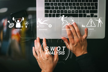 cyber security internet and networking concept.Businessman hand working mobile phone on laptop computer background